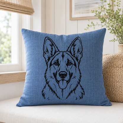A square blue throw pillow with a black line art illustration of a German Shepherd dog, displayed on a light beige cushion in a bright, modern room setting.