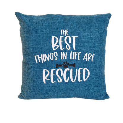 A close up of a blue cushion cover with text the best things in life are rescued on beige sofa in Australia by Rieko's World.