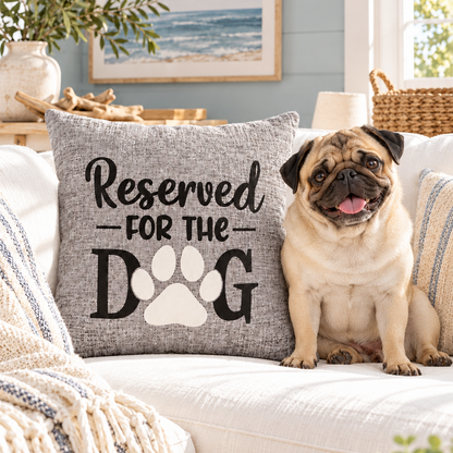 Pug leaning on grey reserved for the dog cushion