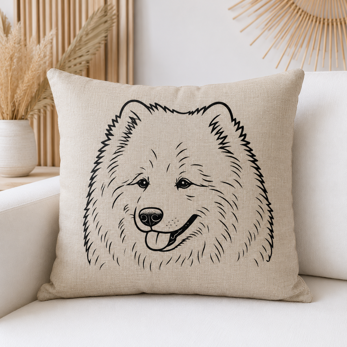 A square beige throw pillow with a black line art illustration of a fluffy dog face, resting on a white sofa in a styled living room setting.
