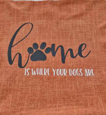 A orange cushion cover with the text 'Home is Where Your Dogs Are' and a paw print design - Dog gift, Australia by Rieko's World.