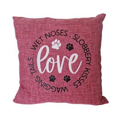 A pink cushion cover with the word 'love' and dog-related phrases such as 'wagging tails', 'wet noses', and 'slobbery kisses' printed on it, along with paw prints - dog gift in Australia made by Rieko's World.