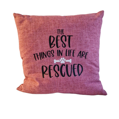 A close up of a pink cushion cover on white background with text the best things in life are rescued on beige sofa in Australia by Rieko's World.