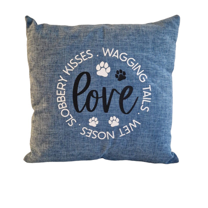 A blue cushion cover close up image with the word 'love' and dog-related phrases such as 'wagging tails', 'wet noses', and 'slobbery kisses' printed on it, along with paw prints - dog gift in Australia made by Rieko's World.