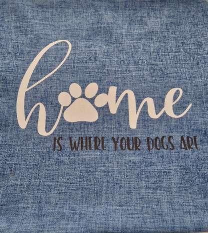 A blue cushion cover with the text 'Home is Where Your Dogs Are' and a paw print design - dog gift, Australia by Rieko's World