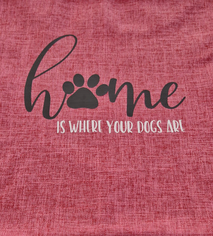 Close up of a pink cushion cover with the text 'Home is Where Your Dogs Are' and a paw print design - Dog gift Australia by Rieko's World